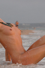 Naked blonde girl posing by the sea-15