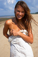 Naked teen poses in the sand-00