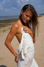 Naked teen poses in the sand-01