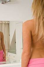 Gorgeous blonde lotions her breasts-05