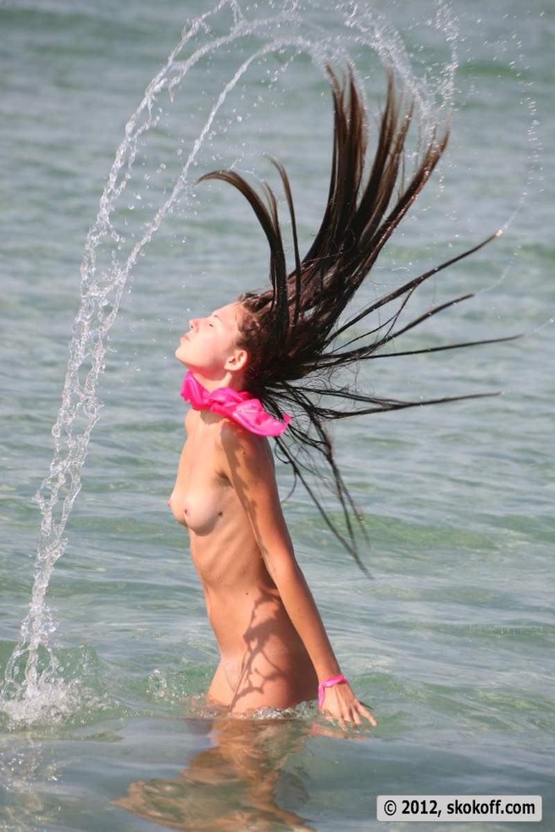 Teen girl gets naked at the beach-17